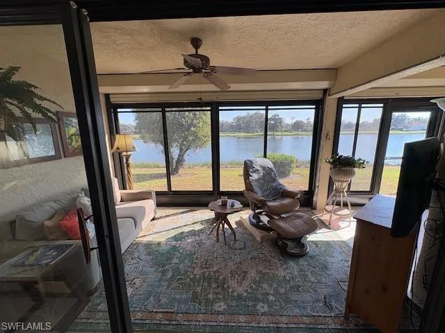 Sunroom featuring a textured ceiling and healthy amount of natural light