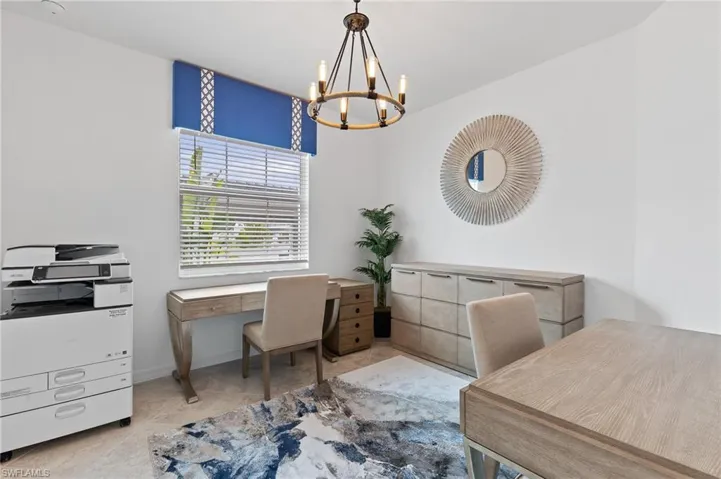 Office with a chandelier and baseboards