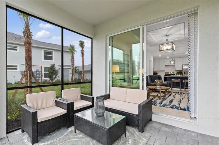 Sunroom with a chandelier and outdoor lounge area
