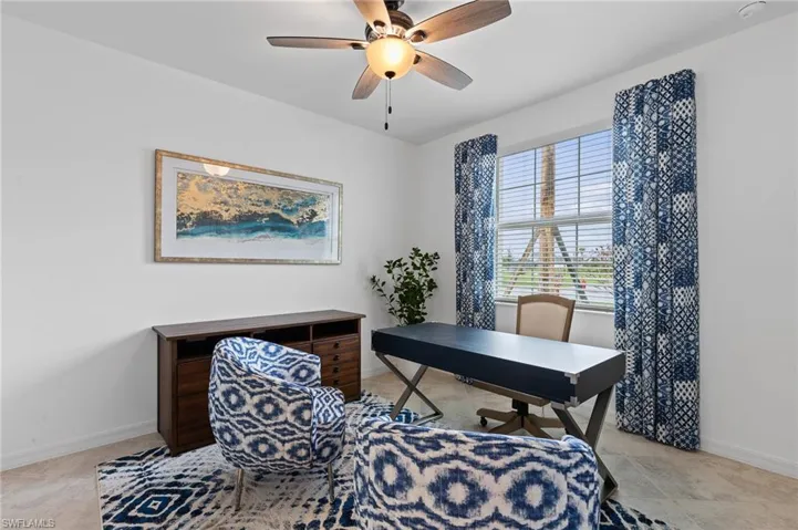 Office space featuring baseboards and a ceiling fan