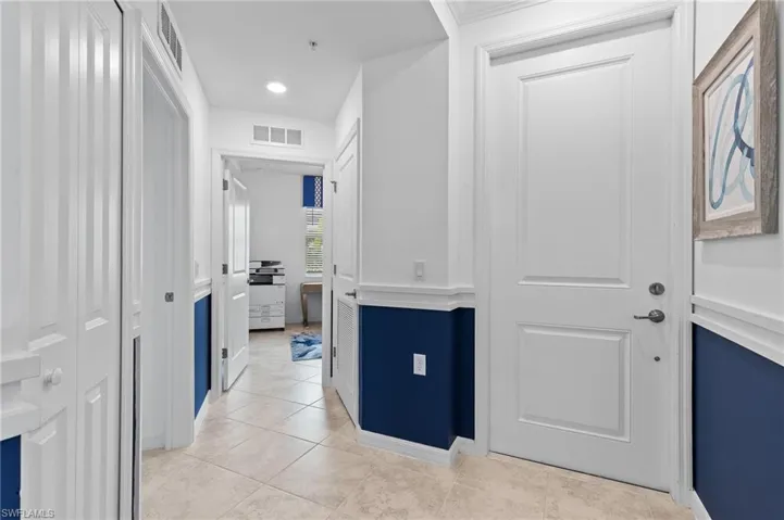 Corridor featuring light tile patterned floors and recessed lighting