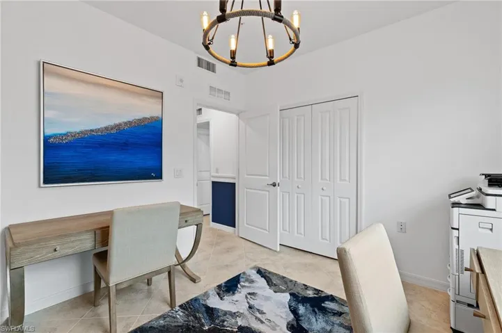 Office featuring a chandelier and baseboards