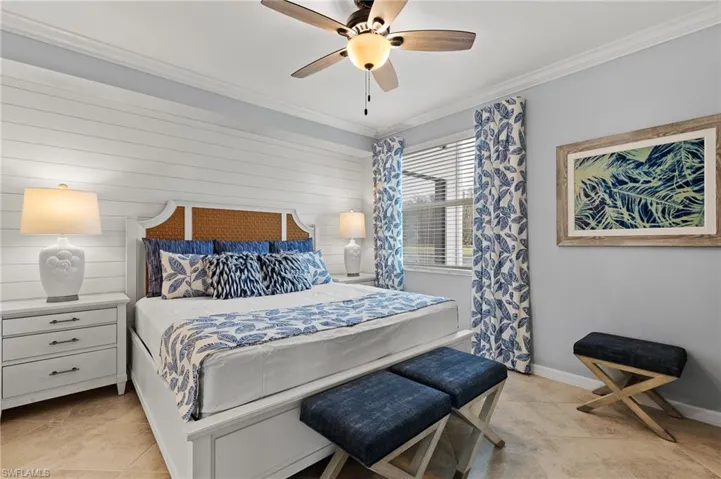 Bedroom with crown molding, light tile patterned floors, and a ceiling fan