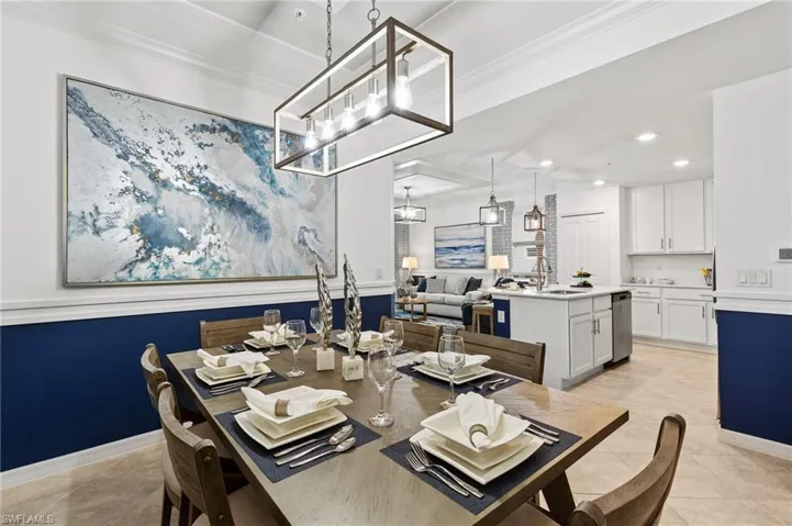 Dining space with a chandelier, recessed lighting, crown molding, and light tile patterned flooring