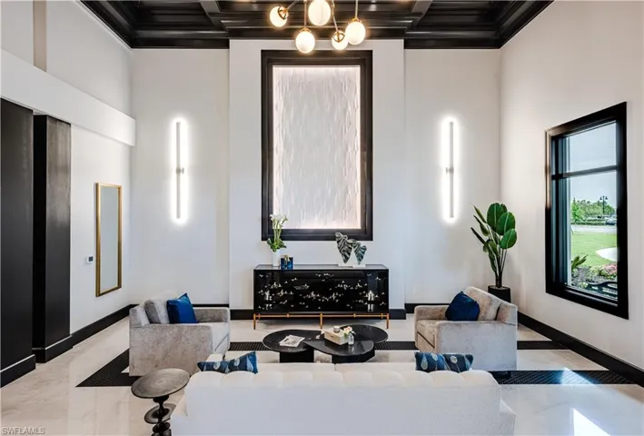 Lobby with coffered ceiling, beamed ceiling, and a high ceiling
