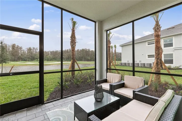 Sunroom / solarium featuring an outdoor hangout area and view of scattered trees