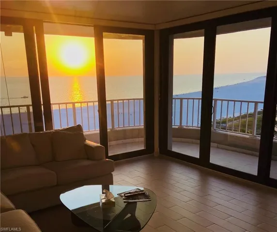 Living room featuring a view of the beach and a water view