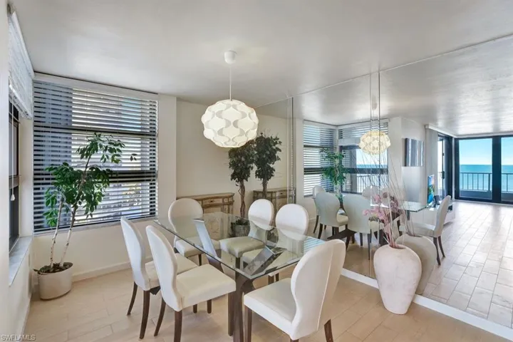 Dining room with a notable chandelier and light wood-type flooring