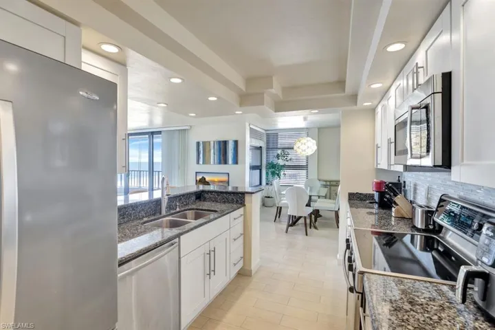 Kitchen featuring sink, white cabinets, plenty of natural light, and appliances with stainless steel finishes