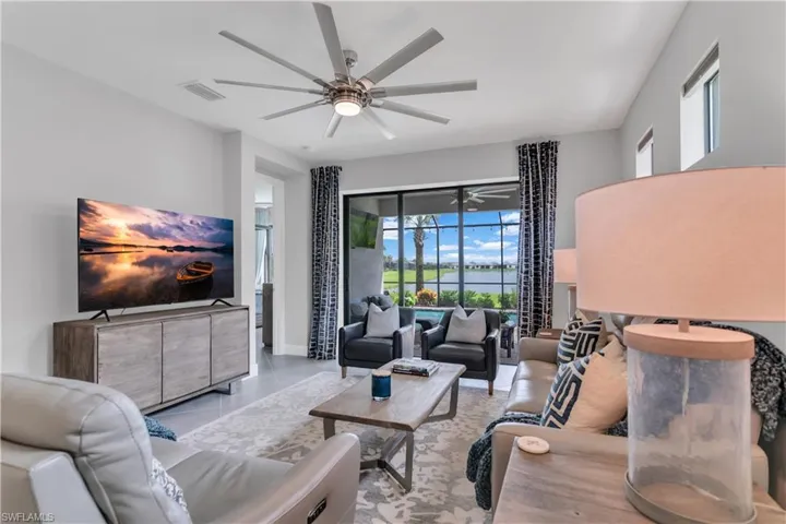 Tiled living room featuring ceiling fan