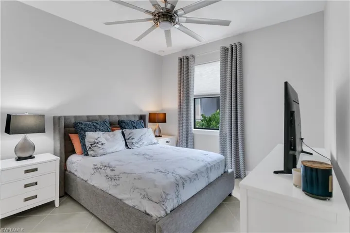 Tiled bedroom with ceiling fan