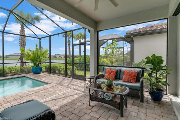 Sunroom featuring a water view and ceiling fan