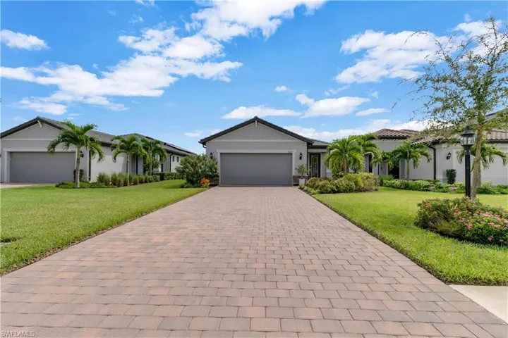 Single story home with a garage and a front yard
