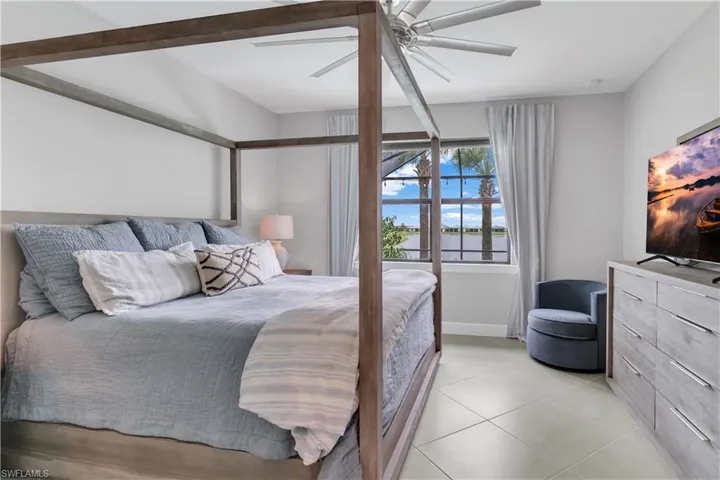 Bedroom with light tile patterned floors and ceiling fan