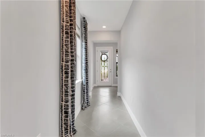 Corridor featuring light tile patterned floors
