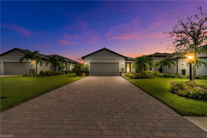 View of front of house featuring a garage and a yard