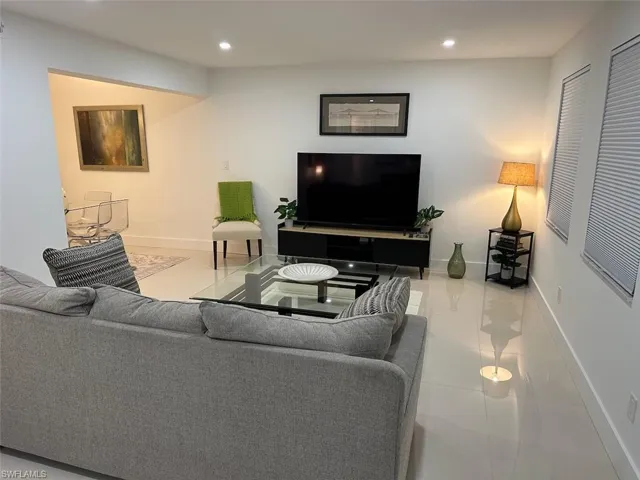 Living room with recessed lighting and light tile patterned floors