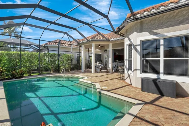 Swimming pool featuring a patio area, a lanai, ceiling fan, and a sunroom