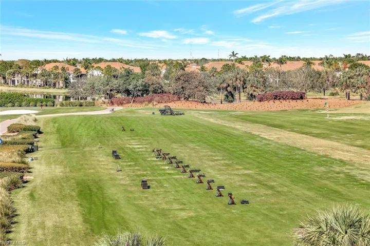 View of property's community featuring view of scattered trees, a water view, and view of golf course
