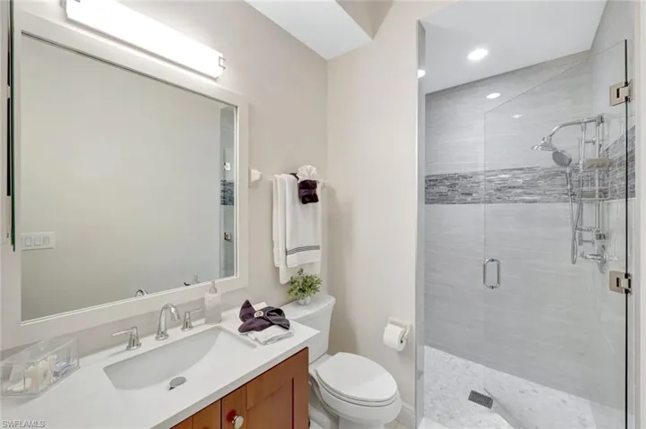 Full bath with vanity and a shower stall