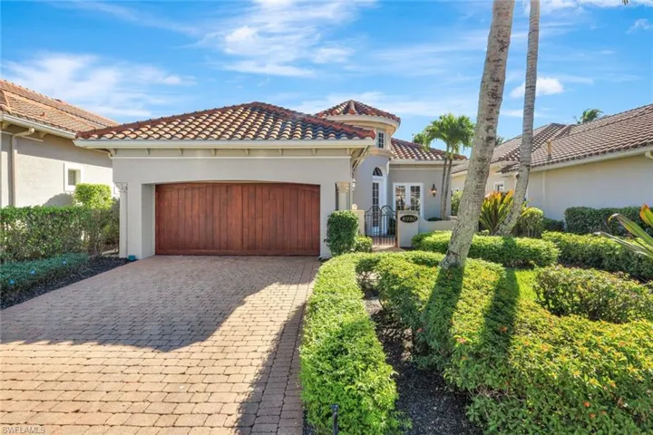 Mediterranean / spanish home featuring stucco siding, decorative driveway, an attached garage, and a tiled roof