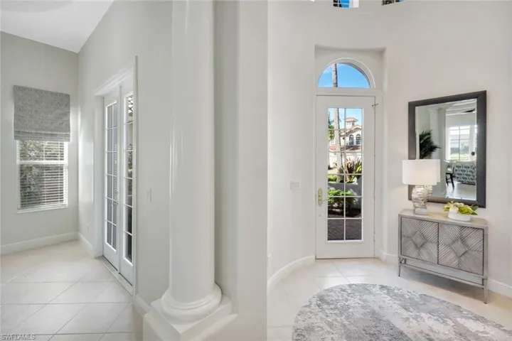 Entryway featuring light tile patterned floors and plenty of natural light