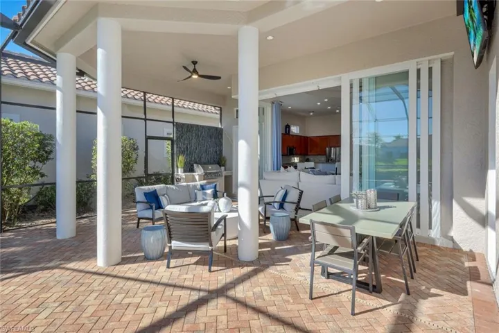 View of patio featuring outdoor lounge area, a ceiling fan, grilling area, and a lanai