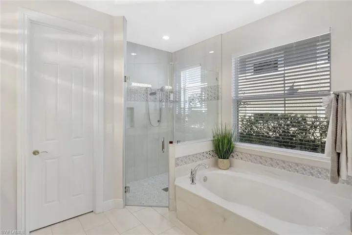 Full bathroom with a stall shower, light tile patterned floors, a bath, and recessed lighting