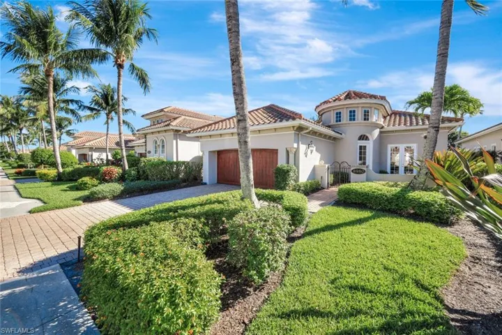 Mediterranean / spanish-style house with stucco siding, a garage, a tile roof, decorative driveway, and a gate