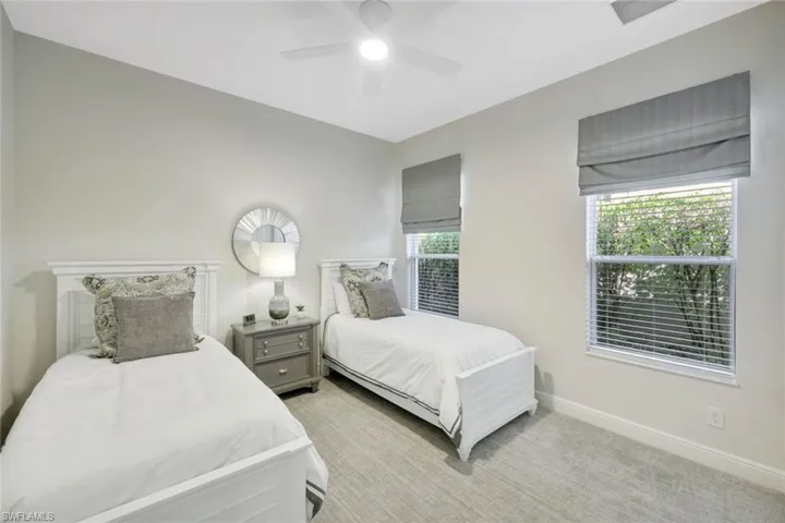 Bedroom featuring light colored carpet and a ceiling fan