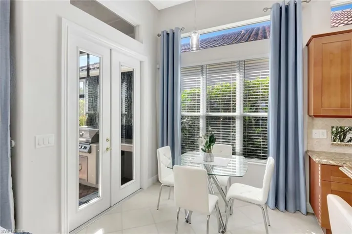 Dining area with light tile patterned flooring
