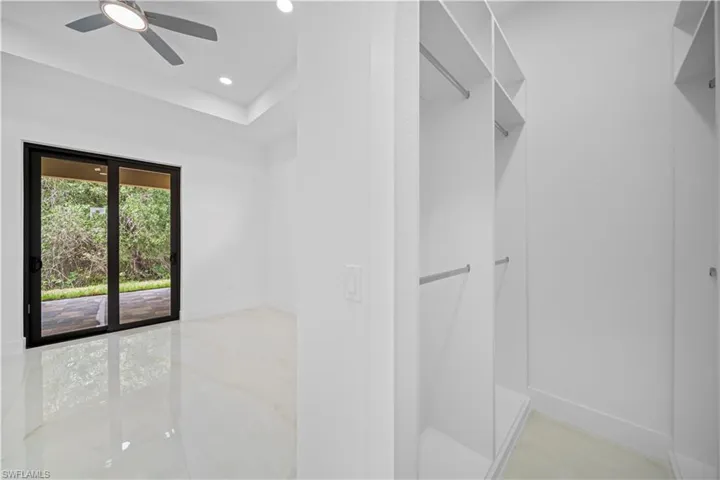 Walk-in closet with integrated shelving and hanging rods