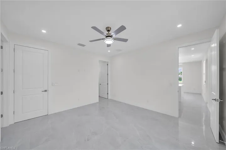 Spare room featuring recessed lighting, a ceiling fan, visible vents, baseboards, and marble finish floor