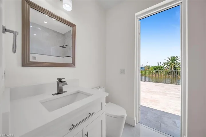 Bathroom featuring toilet, a water view, and vanity