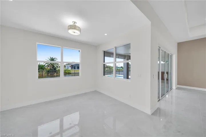 Empty room featuring marble finish floor and baseboards
