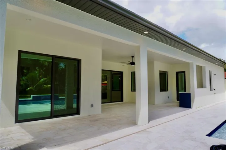 View of patio featuring a ceiling fan and an outdoor pool