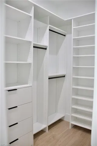 Walk in closet featuring light wood-style floors