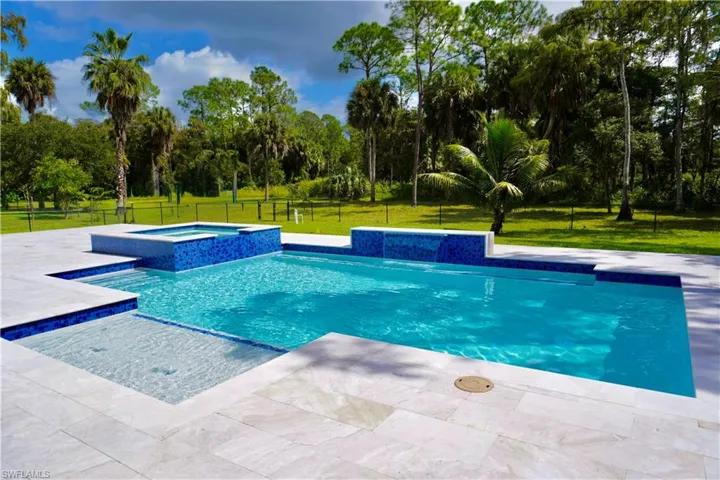 View of swimming pool with a pool with connected hot tub and a patio