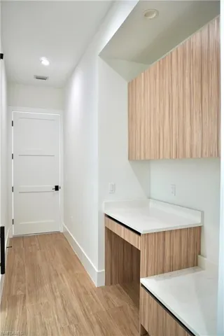Hall featuring light wood-style floors and recessed lighting