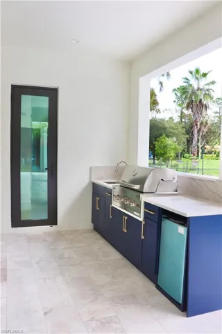 View of patio / terrace featuring an outdoor kitchen and a sink