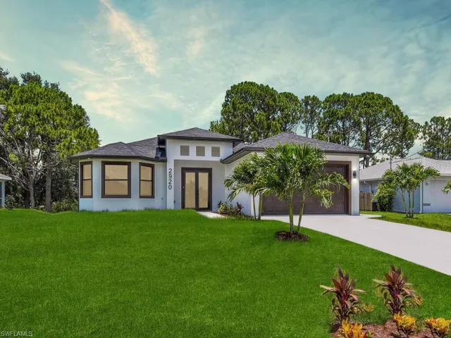 Prairie-style home with a garage and a front lawn