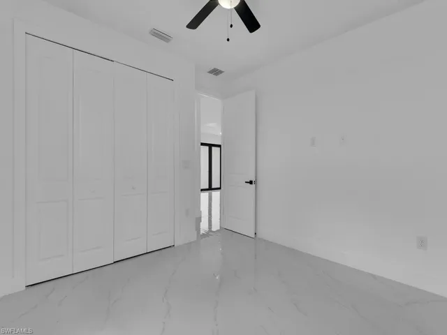 Unfurnished bedroom featuring a closet, ceiling fan, and tile patterned flooring