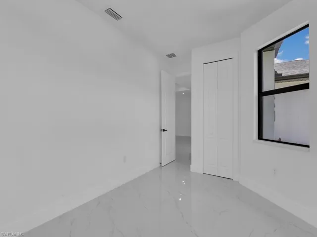 Empty room featuring light tile patterned floors