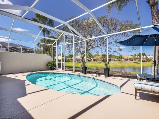 Swimming pool with a sunroom, a lanai, a patio, and a water view