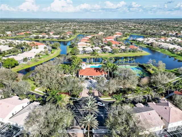 Aerial view of residential area featuring a nearby body of water