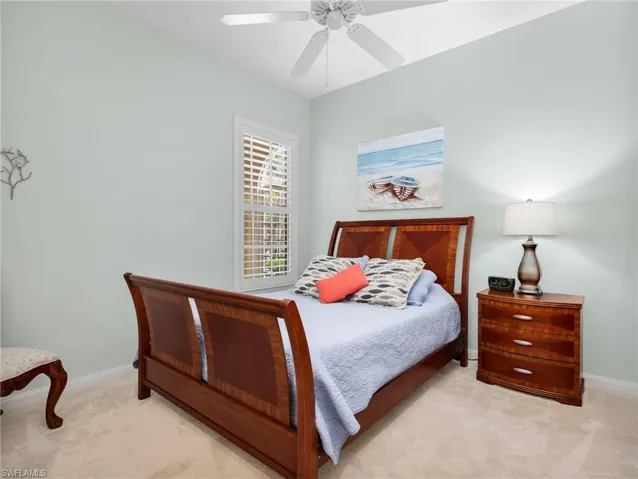 Bedroom featuring light carpet and a ceiling fan