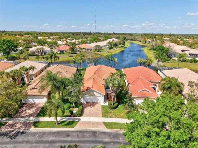 Aerial view of residential area featuring a nearby body of water