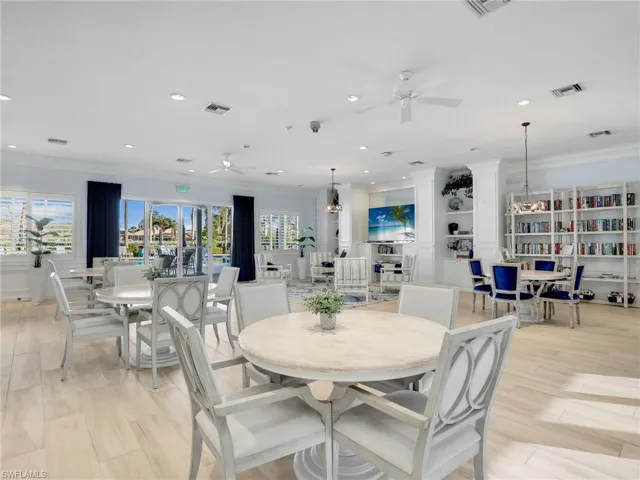 Dining area with light wood-style flooring, crown molding, recessed lighting, and ceiling fan