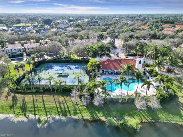 Aerial view of residential area with a pool area and a nearby body of water