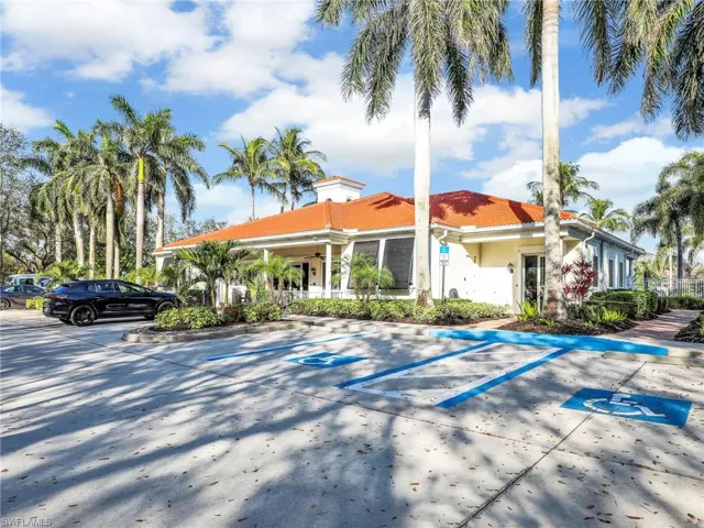 View of property featuring uncovered parking